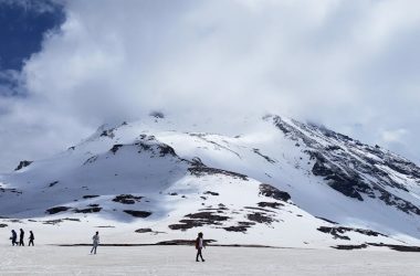 Scenic view of snow-capped peaks under cloudy skies in Rohtang, Himachal Pradesh.
