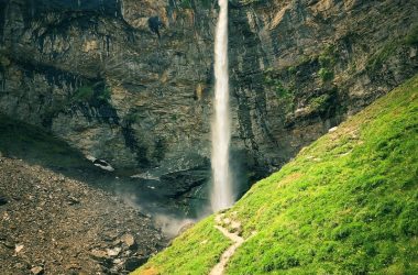 Stunning view of a waterfall cascading down rocky cliffs in Sissu, Himachal Pradesh.